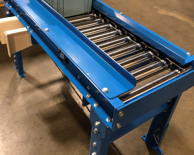 Blue metal roller conveyor with cylindrical rollers and adjustable legs on concrete floor